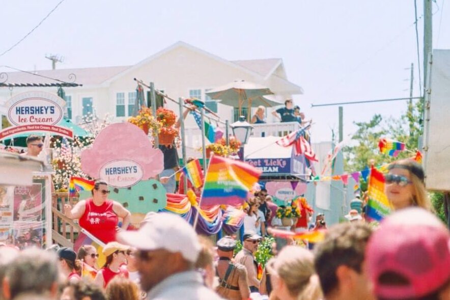 Crowd of people walking through Cherry Grove during a busy summer afternoon, for the annual pride parade.